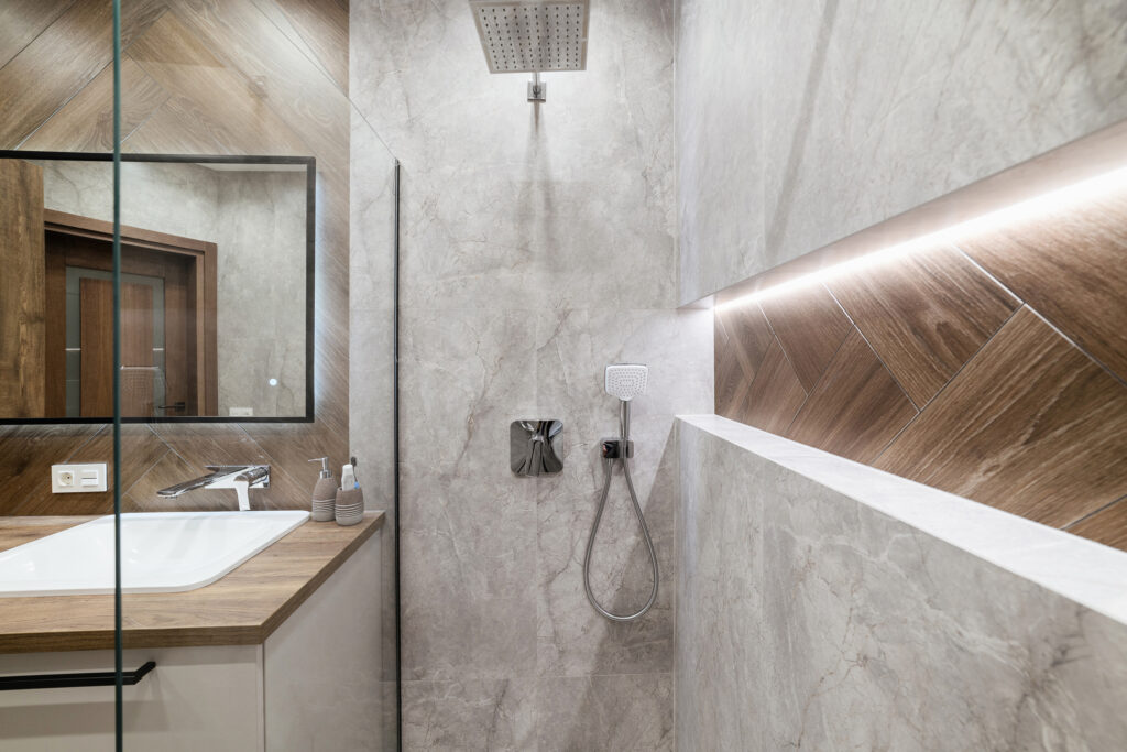 shower with glass and lighting in the new bathroom in the house