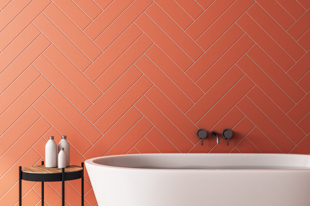 Contemporary orange bathroom interior with bath tub, sunlight and copy space. 3D Rendering