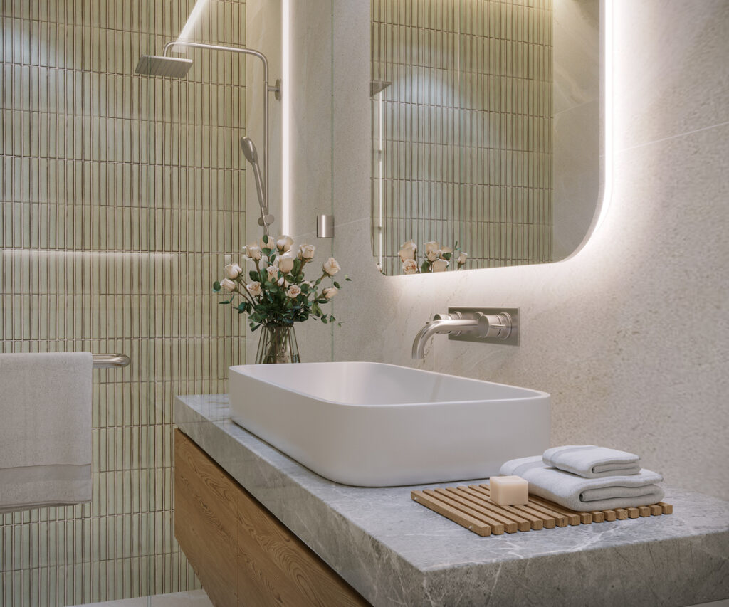 Modern bathroom vanity with vessel sink, textured green tile accent wall, wall-mounted faucet, and illuminated mirror