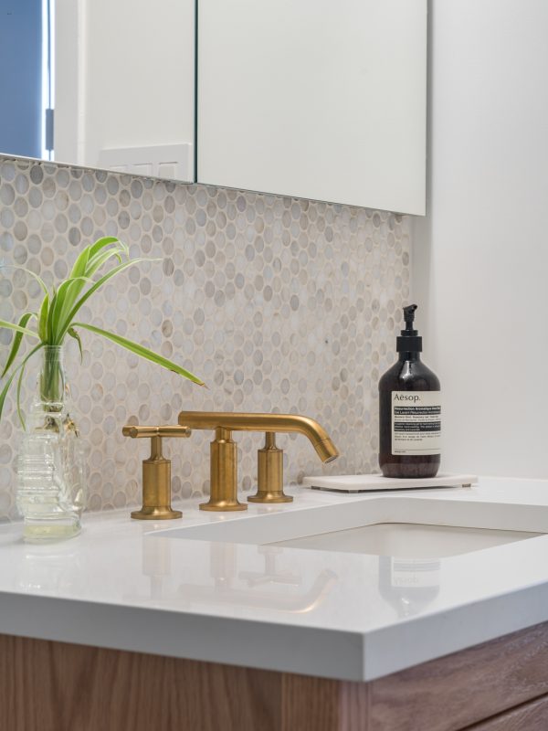White sink with gold faucet nyc bathroom